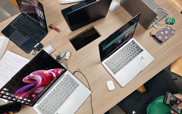 A team working across laptops — mapping AI opportunities during a Paxlan snapshot.